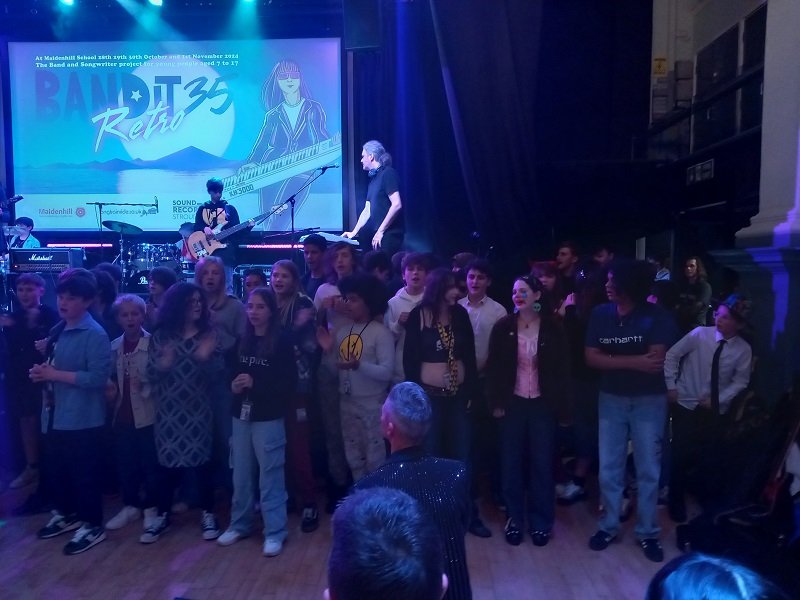 A packed crowd of young performers at the Stroud Subscription Rooms during a Bandit final show
